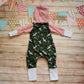 Rear of the roarsome Christmas dinosaurs hooded popper romper. Handmade using dark green festasaurus, red striped and white cotton jerseys. Perfect for the dinosaur fanatic in your life! 