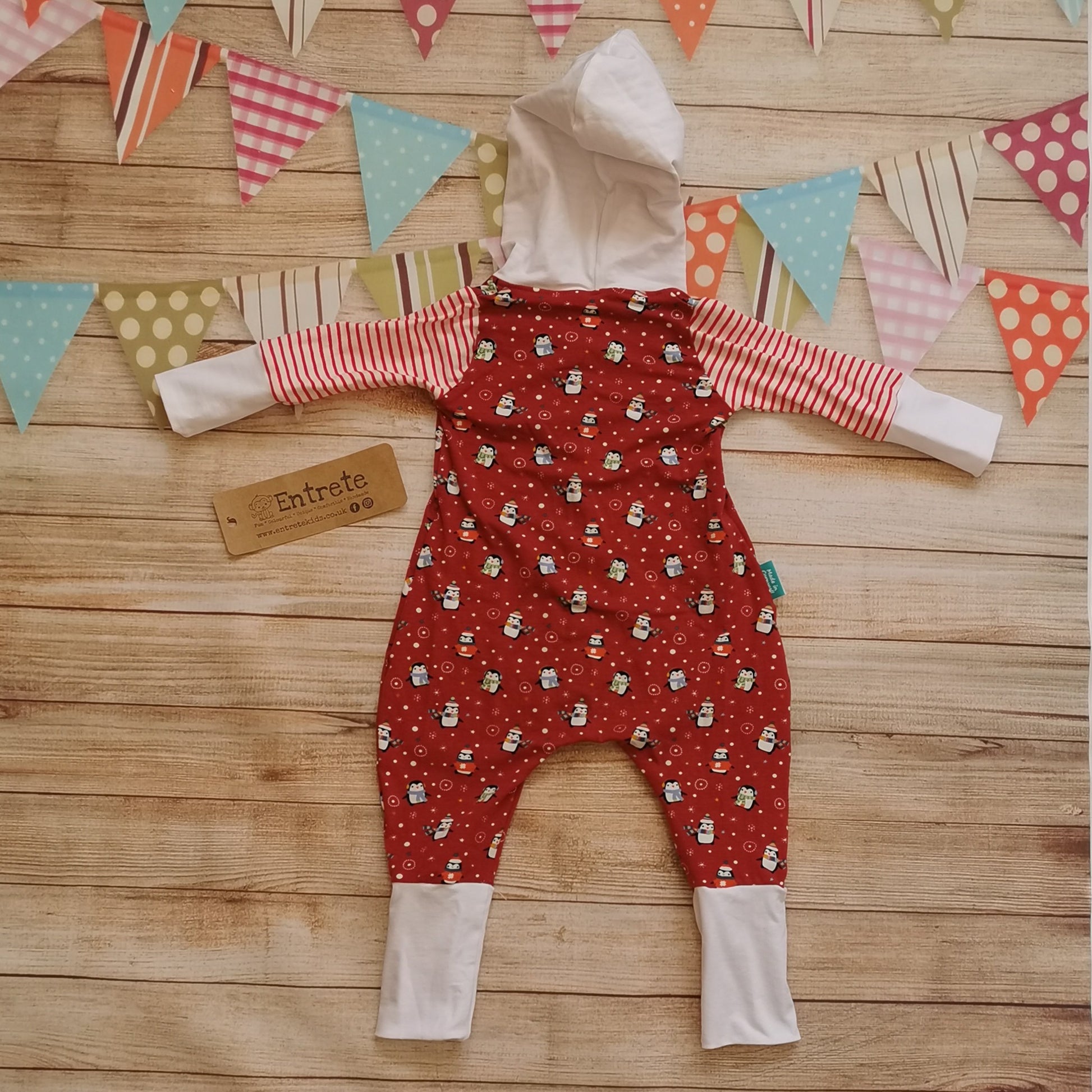 Rear of the epic christmas penguins hooded popper romper. Handmade using red penguins, red striped and white cotton jerseys for the perfect Christmas loungewear!