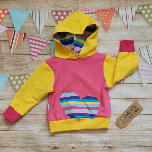 Stunning girls hoodie, handmade with a warm, pink cotton sweatshirt fleece body, yellow french terry arms and hood and yellow and fuchsia cotton ribbing. Featuring cerise rainbow striped cotton jersey hood lining and heart detailing.