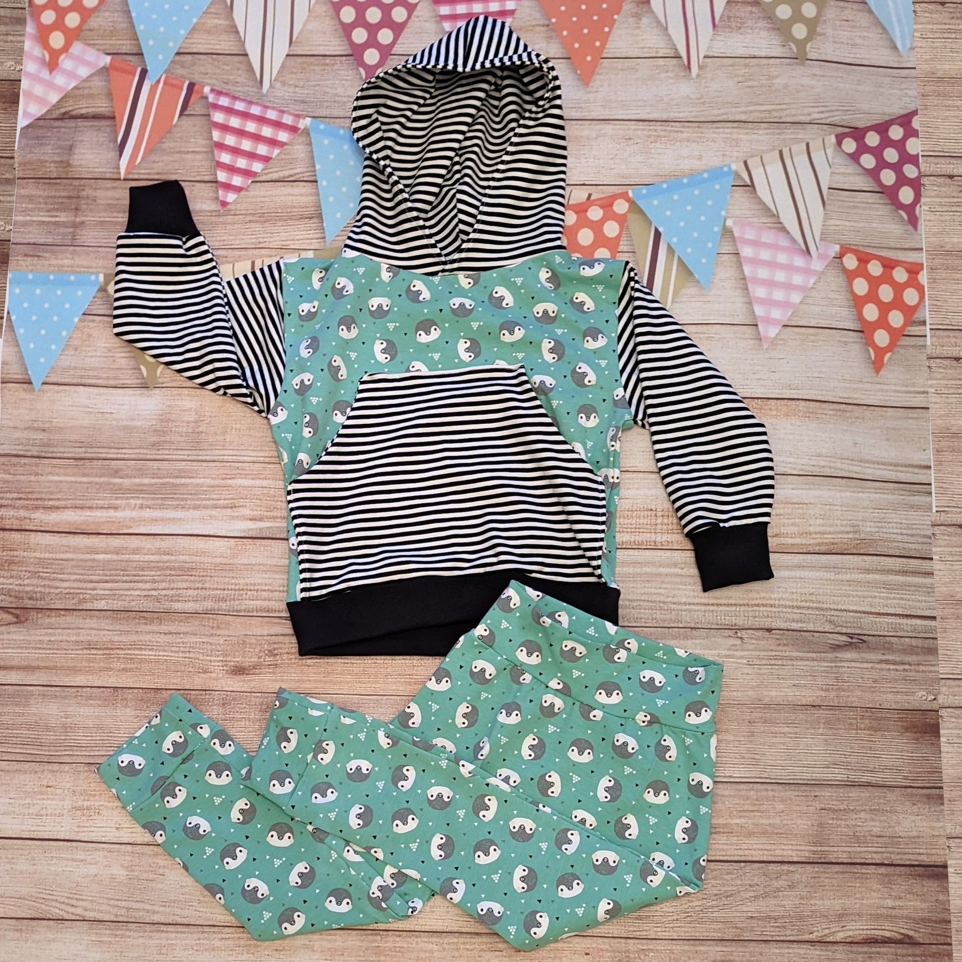 The adorable mint penguins and striped hoodie shown as an outfit with a pair of organic mint penguins harem pants.