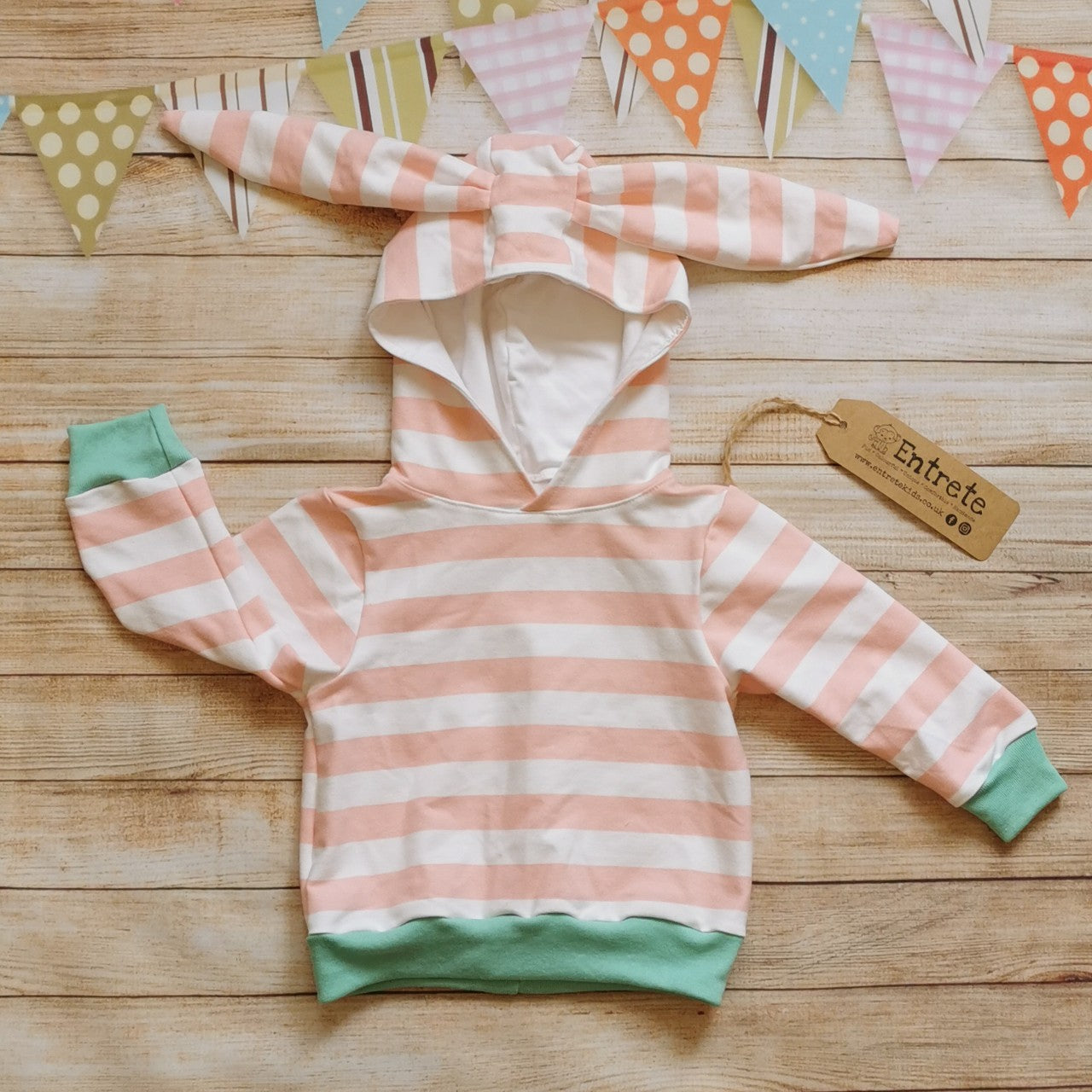 The lightweight pink striped bunny hoodie, with fun bunny ears on the hood. Handmade using pink striped cotton French terry, white cotton jersey and mint cotton ribbing.