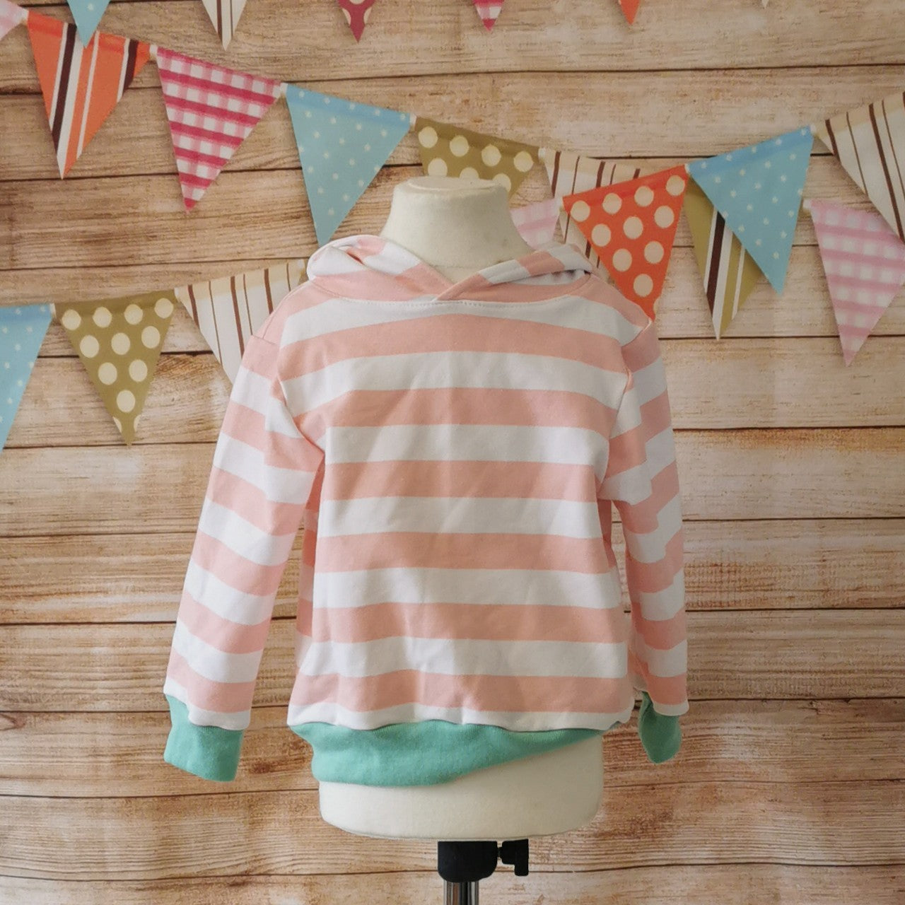 The lightweight pink striped bunny hoodie, with fun bunny ears on the hood. Handmade using pink striped cotton French terry, white cotton jersey and mint cotton ribbing. Shown on mannequin.
