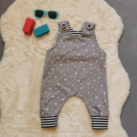 The dreamy grey stars sleeveless romper, soft and comfy with easy on shoulder popper entry. Handmade using grey stars and monochrome striped cotton jerseys'.