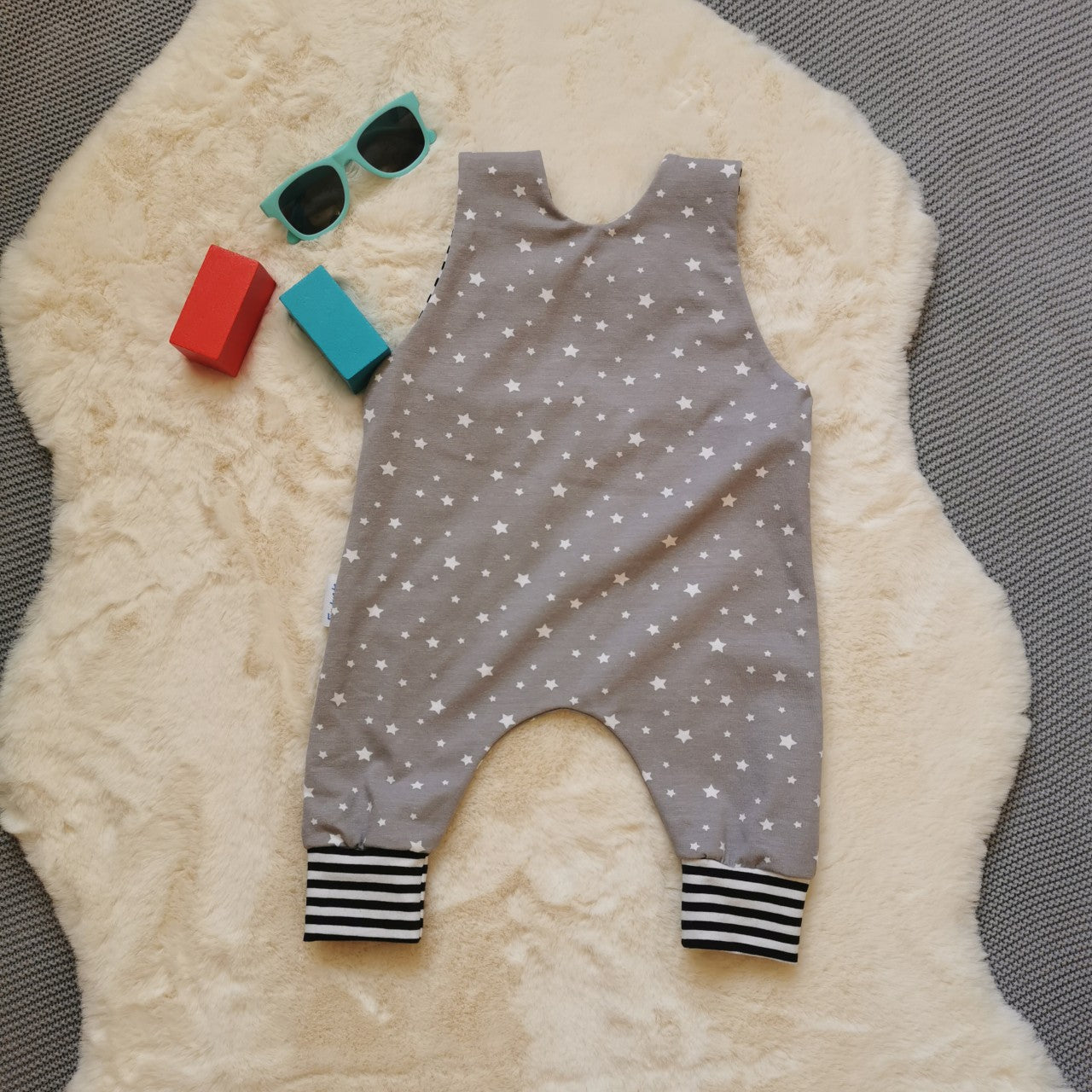 Rear of the dreamy grey stars sleeveless romper, soft and comfy with easy on shoulder popper entry. Handmade using grey stars and monochrome striped cotton jerseys'.
