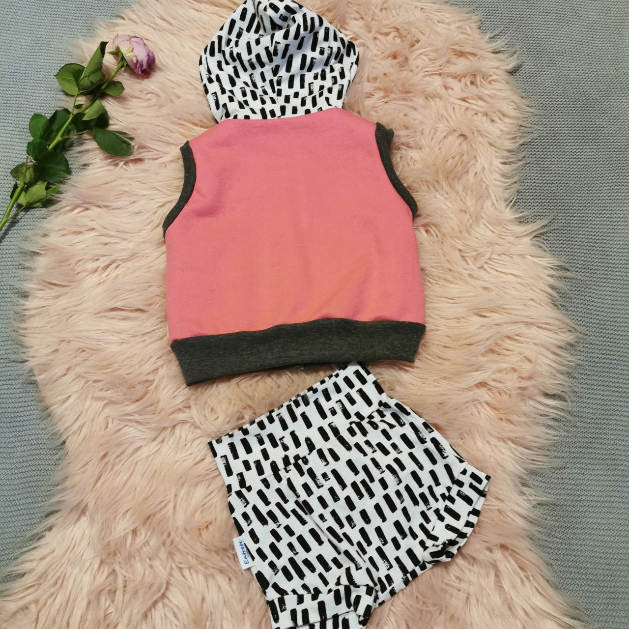 Monochrome abstract stripes shorts shown with a matching reversible sleeveless hoodie. (sold separately)