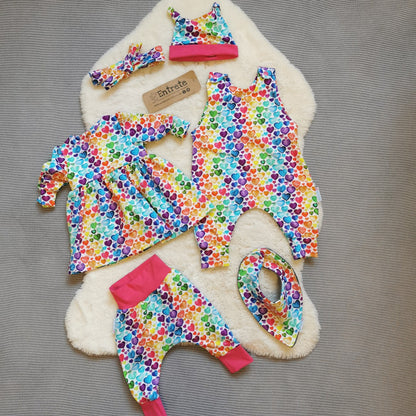 The full gift set, including dress, romper, harem pants, bib and tie top hat. Shown in rainbow hearts for demonstration purposes. Your gift set will be made using turquoise boom pow wow cotton jersey.