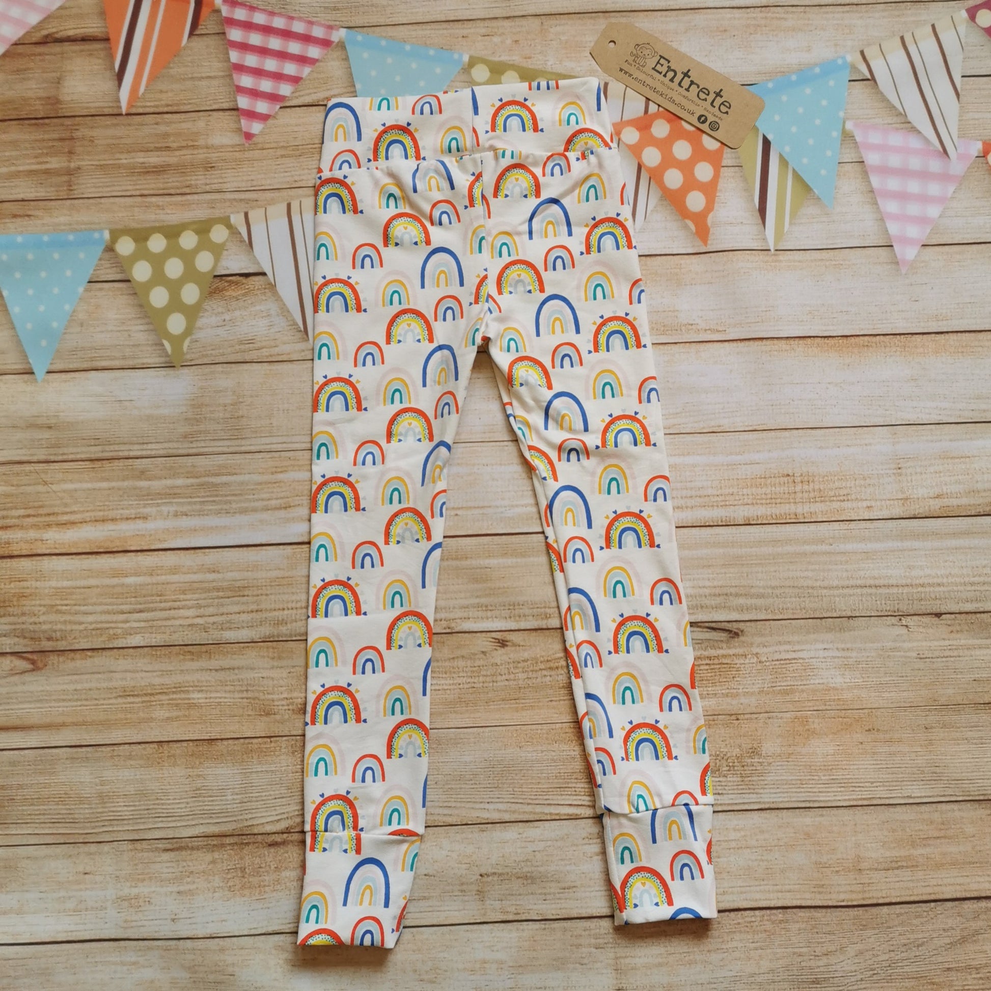 Rear of  soft and stretchy kids leggings, handmade using white colourful rainbows and hearts cotton jersey.
