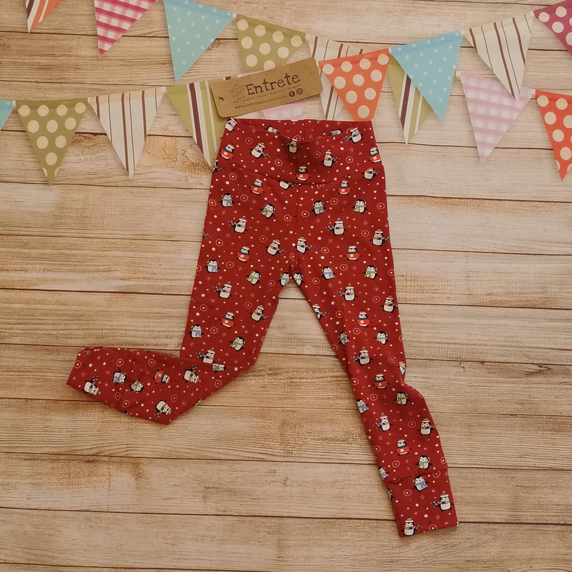 Soft, comfy and very Christmassy! Leggings handmade using festive and fun red penguins cotton jersey. Shown from the front.