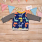 Colourful and fun blue dinosaurs short sleeved T-Shirt, shown from the rear. Handmade using blue dinosaurs cotton jersey and yellow cotton ribbing.