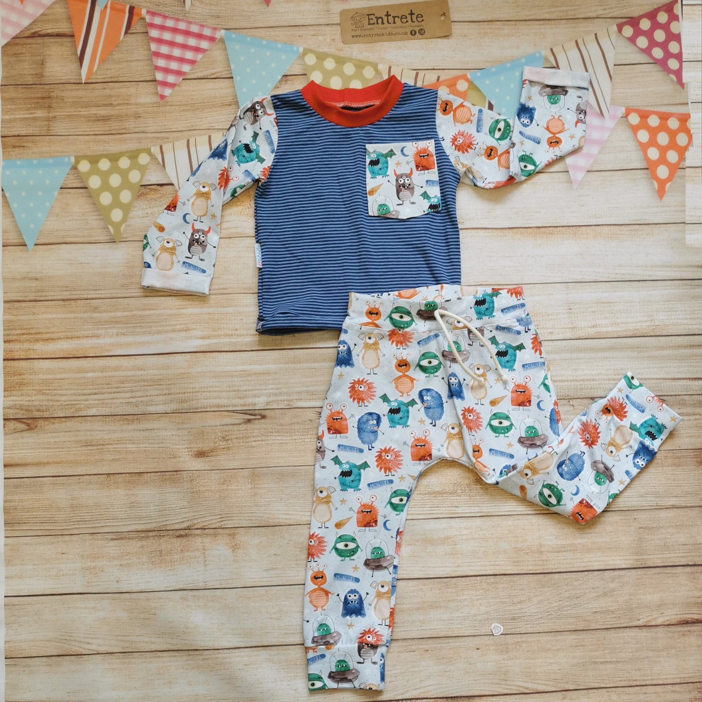Fun and colourful monsters & navy striped long sleeve t-shirt shown with matching pale blue monster joggers (sold separately). Handmade using pale blue organic monsters cotton jersey on navy striped cotton jersey. With red cotton ribbing neck.