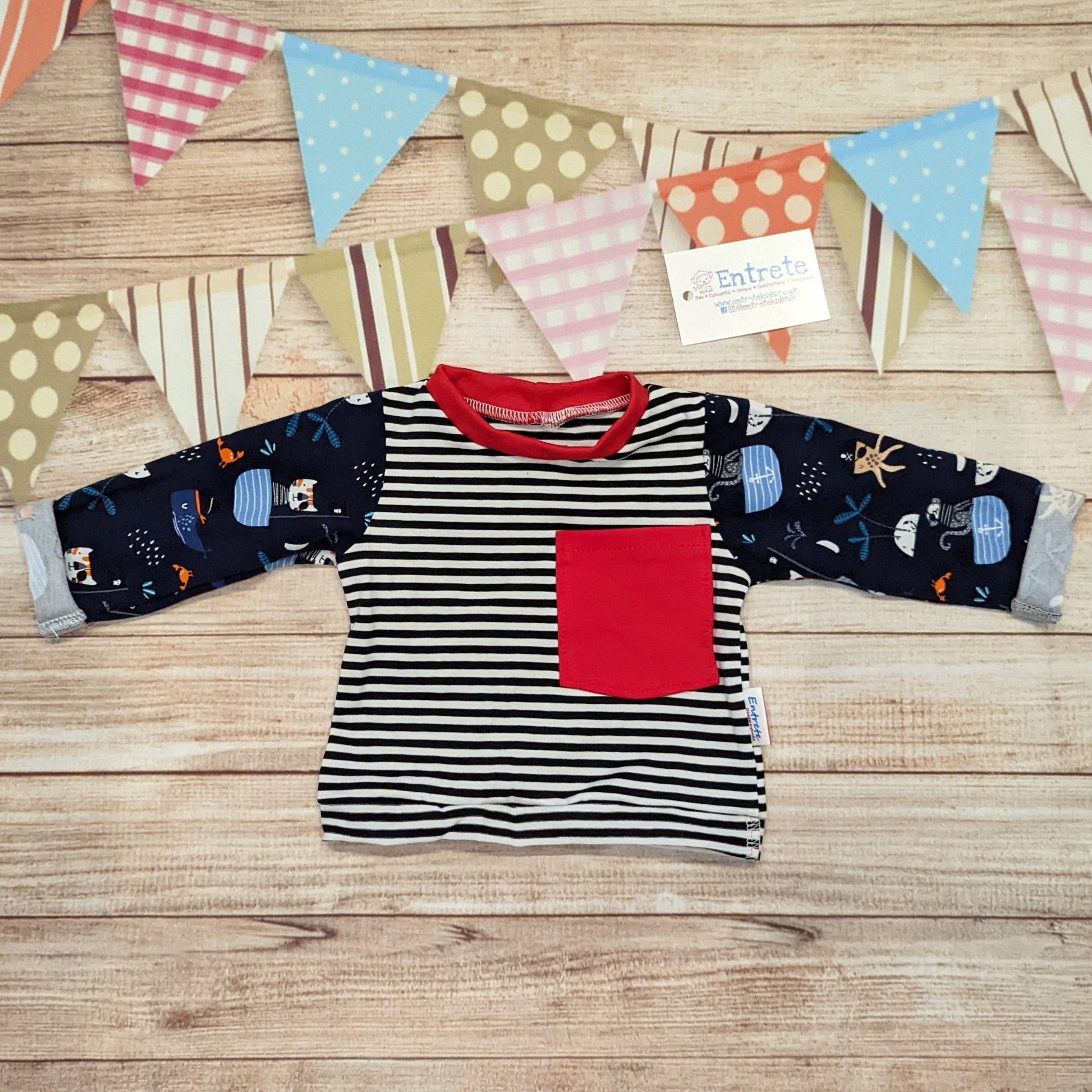 Long sleeved pirate cats T-shirt, featuring rolled cuffs and waist and a contrasting front pocket. Handmade using pirate cats, monochrome striped and red cotton jersey's with red cotton ribbing.
