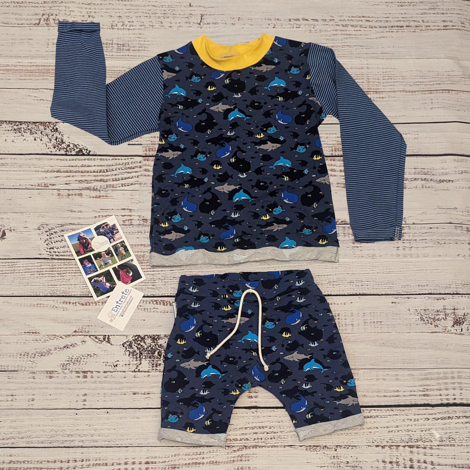 Kids sea creatures harem shorts. Handmade using navy sea life shadows cotton jersey. Shown as an outfit with a matching long sleeve T-shirt.