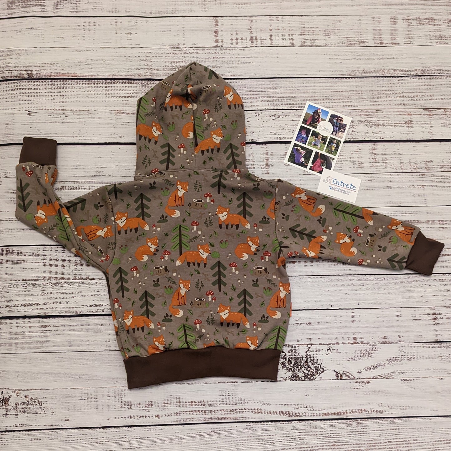 The sumptuously soft forest foxes popper hoodie. Handmade using forest foxes alpine fleece, chocolate cotton ribbing and orange cotton jersey.   Shown from the rear.