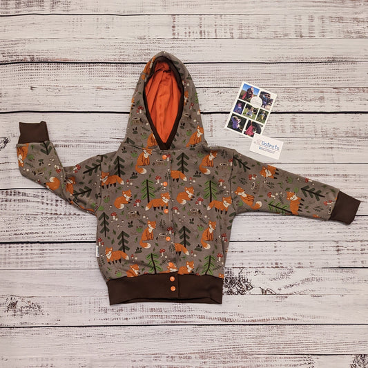 The sumptuously soft forest foxes popper hoodie. Handmade using forest foxes alpine fleece, chocolate cotton ribbing and orange cotton jersey.  