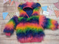 The colourful rainbow bear reversible hoodie. Handmade from rainbow long hair faux fur and fuchsia cotton ribbing, with royal blue cotton jersey on the reverse. Shown from the front.
