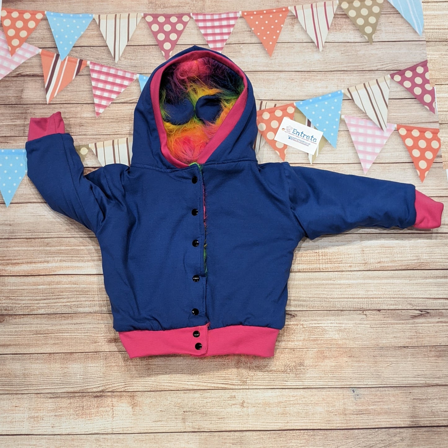 The colourful rainbow bear reversible hoodie. Handmade from rainbow long hair faux fur and fuchsia cotton ribbing, with royal blue cotton jersey on the reverse. Shown on the reverse as a royal blue and fuchsia hoodie.