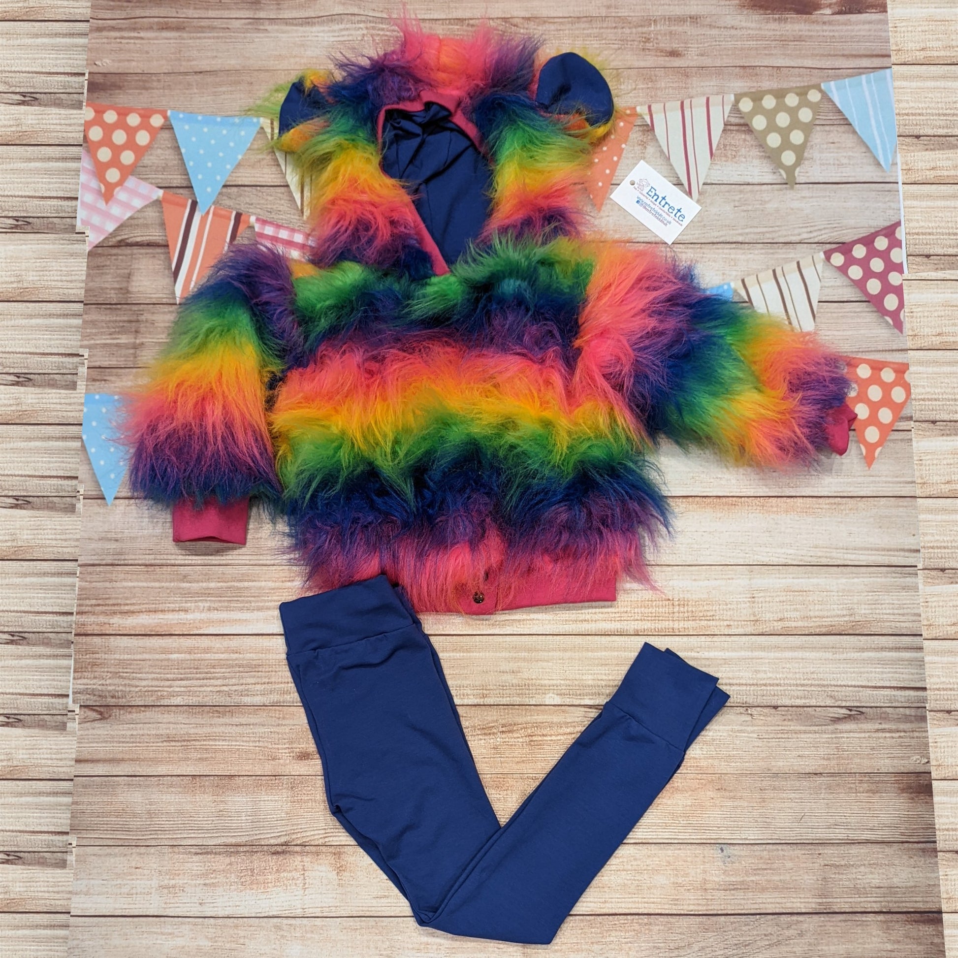 The colourful rainbow bear reversible hoodie. Handmade from rainbow long hair faux fur and fuchsia cotton ribbing, with royal blue cotton jersey on the reverse. Shown as an outfit with royal blue leggings..