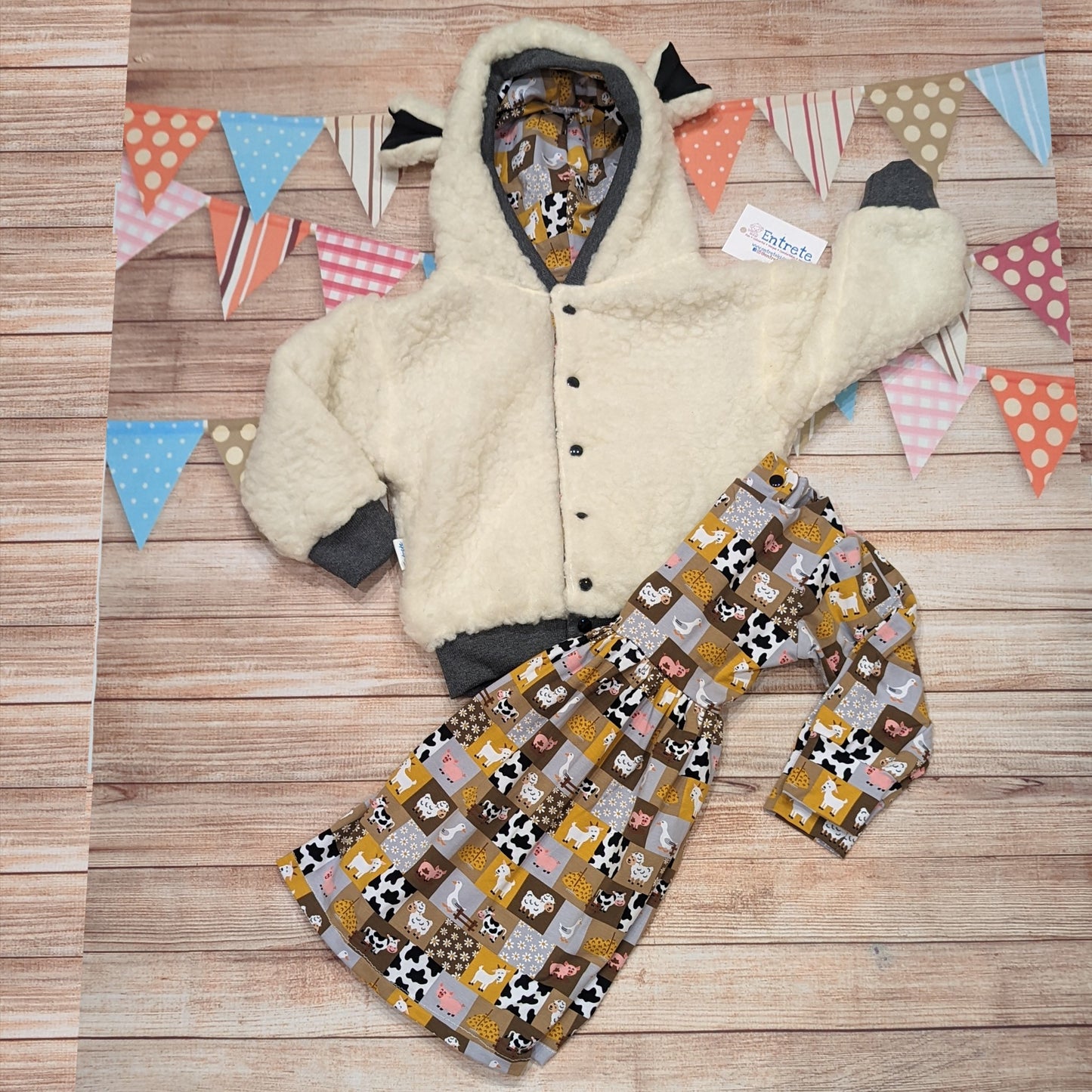 The adorable sheep hoodie handmade using sherpa fur and graphite cotton ribbing, with adorable and fun checkboard farm animals cotton jersey on the reverse. Shown as an outfit with a farm animals dress.