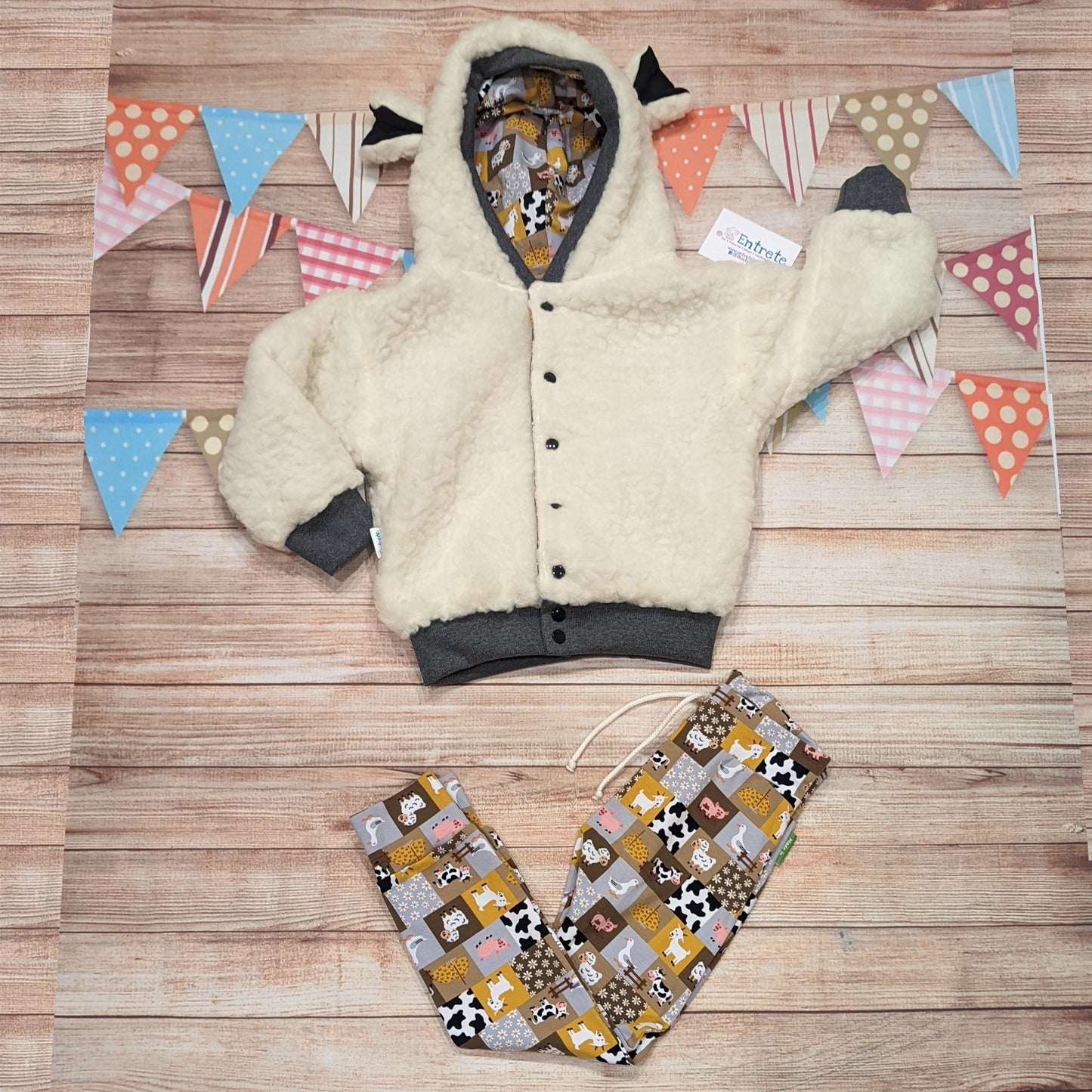 The adorable sheep hoodie handmade using sherpa fur and graphite cotton ribbing, with adorable and fun checkboard farm animals cotton jersey on the reverse. Shown as an outfit with farm animals harem joggers.