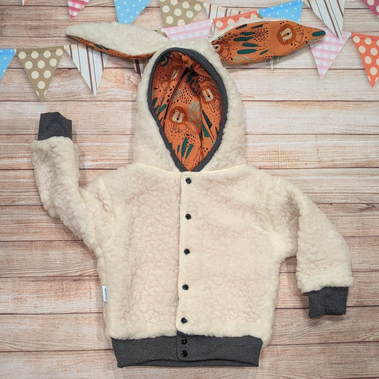 The gorgeous sherpa and orange lions reversible bunny hoodie. Handmade using sherpa fur, graphite ribbing and orange lions cotton French terry. Featuring front poppers and adorable bunny ears on the hood.