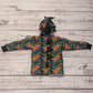 The ferociously cool street Dino reversible coat, shown from the back with dinosaur teeth and spines for added fun. Handmade using street dino cotton French terry, black cotton ribbing and sherpa fur.
