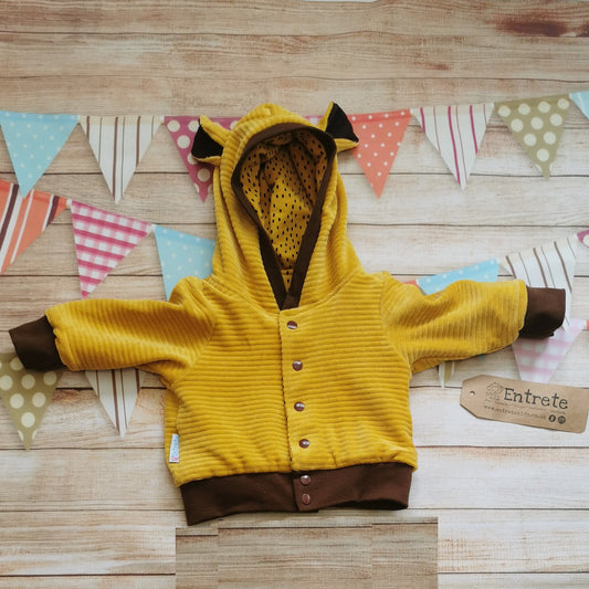 Front view of the amazing reversible lion cub hoodie. Handmade with ochre corduroy and chocolate ribbing with ears on the hood.
