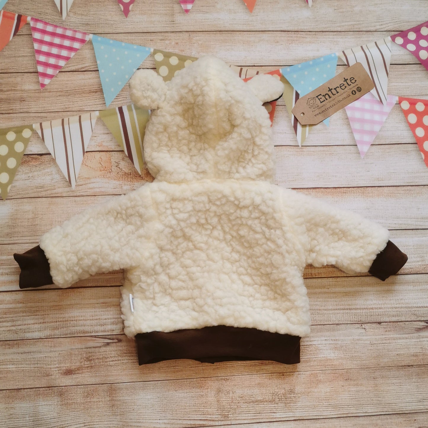Rear view of the adorable reversible sheep hoodie with sherpa fur and ears on the hood.
