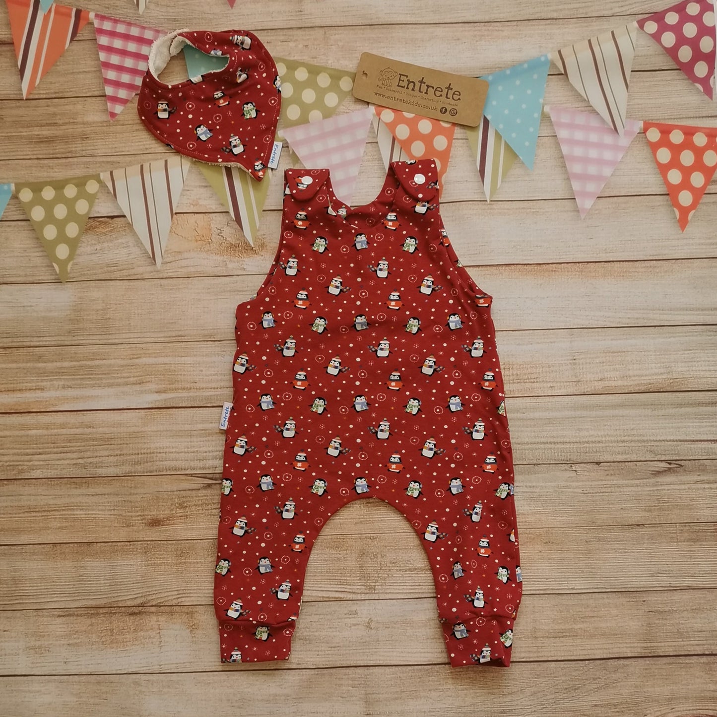 Soft and comfy sleeveless romper, handmade using the festive and fun red penguins cotton jersey. Perfect for Christmas! Shown with a matching bamboo bib. (sold separately)