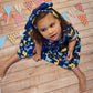 Sophie rocking her blue Dinosaur dress and matching headband.
