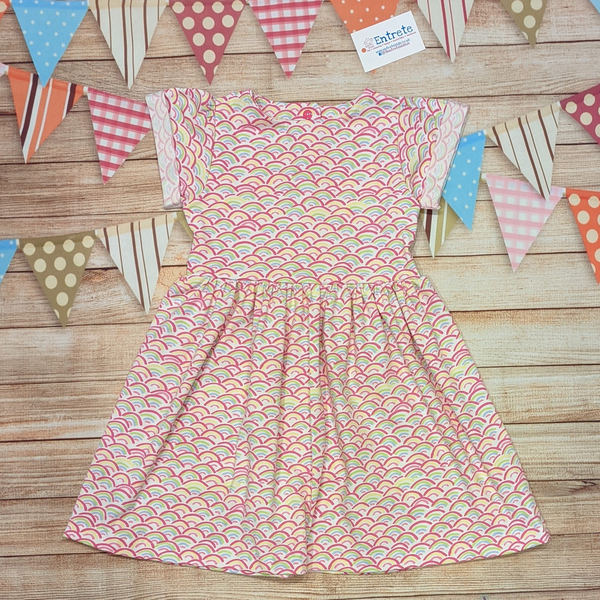 The adorable mini rainbows on white short sleeve dress. Handmade using mini rainbows on white cotton jersey.