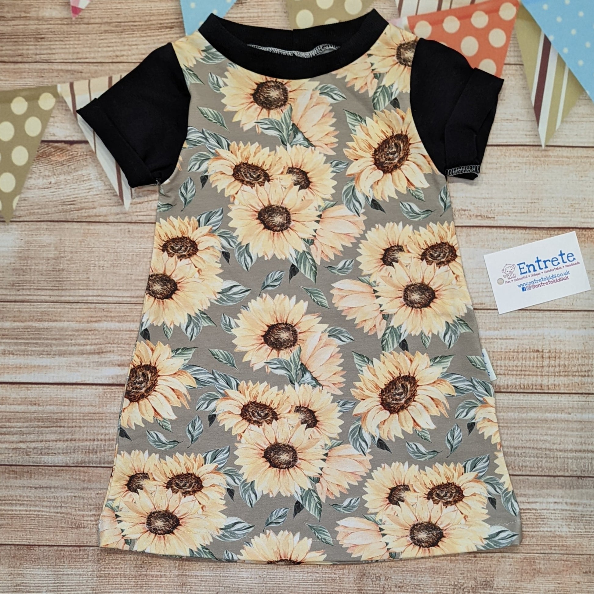 The warm sunflower T-shirt dress, handmade using sunflowers cotton French terry, black cotton jersey and black cotton ribbing. Short sleeved version shown.