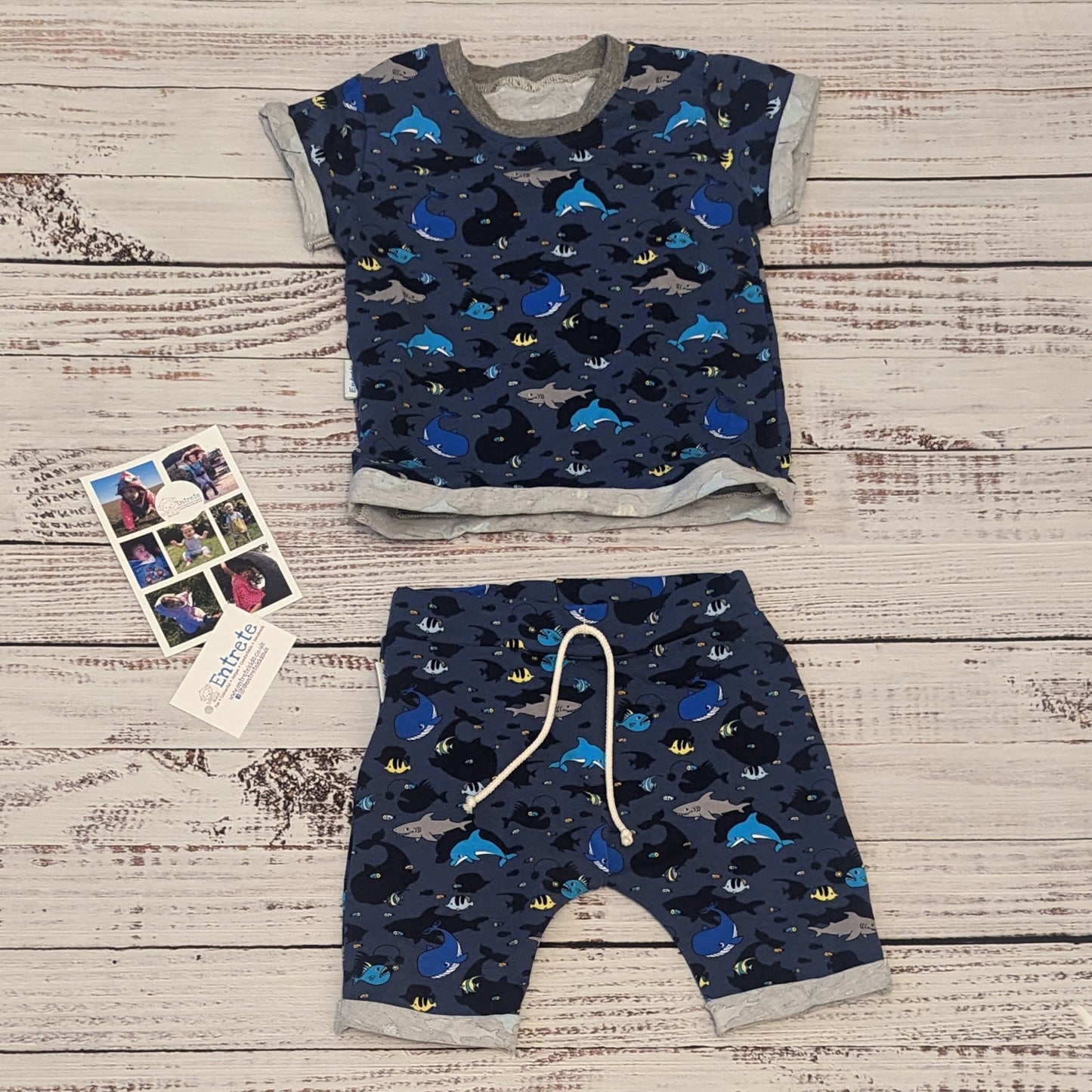 Kids sea creatures harem shorts. Handmade using navy sea life shadows cotton jersey. Shown as an outfit with a matching short sleeve T-shirt.