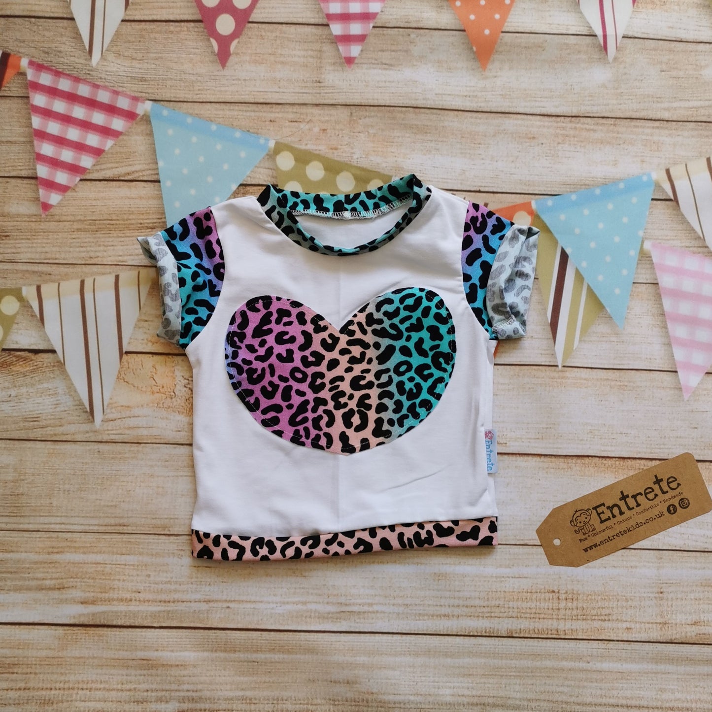 Short sleeve T-shirt, handmade using white cotton jersey offset with stunning bright rainbow leopard print cotton jersey in an adorable heart design. Soft, comfortable, stylish and with a dash of colourful animal print.