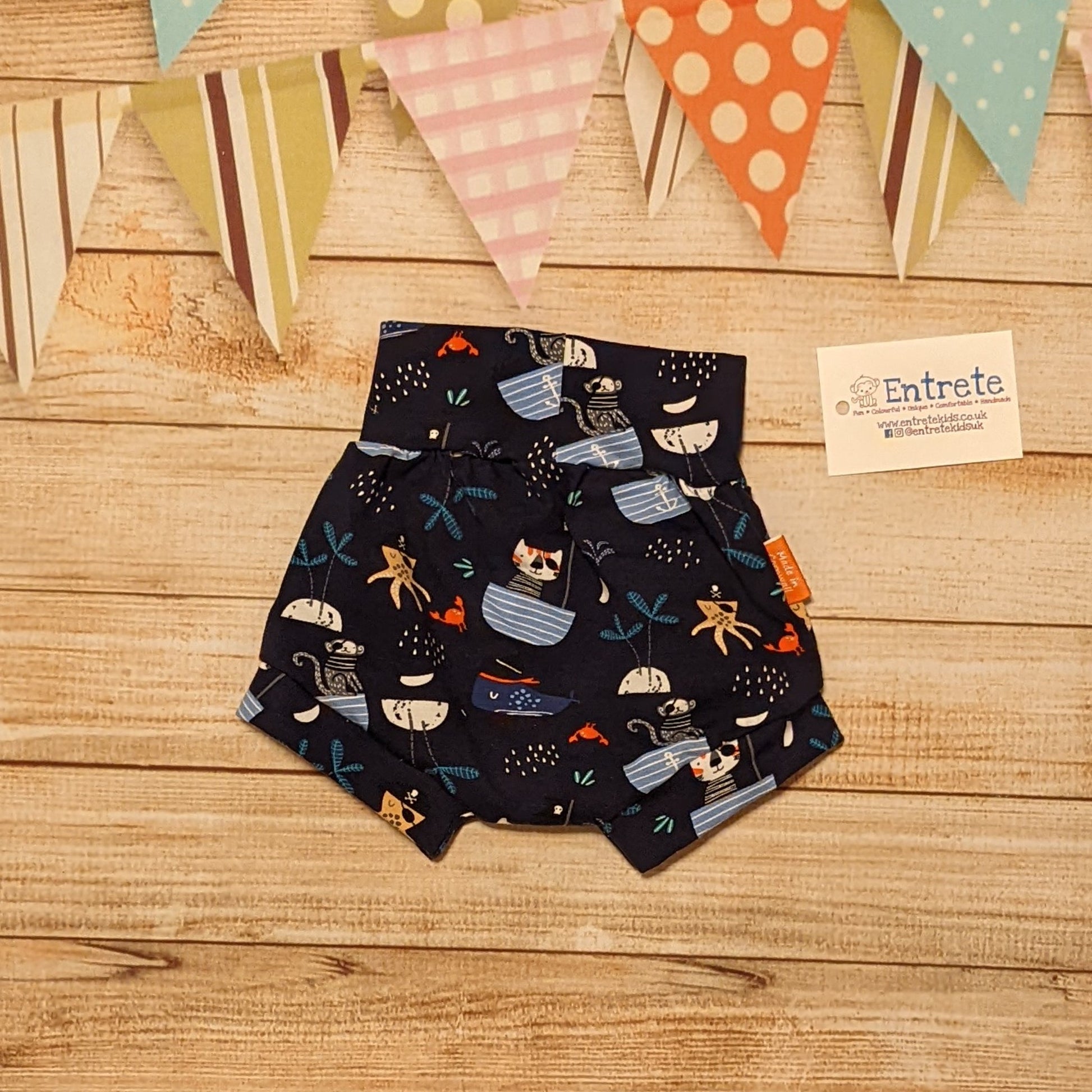 Fun and adventure awaits with these adorable pirate cats shorts. Shown from the rear. Handmade using pirate cats cotton jersey.