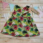 Rear view of the handmade retro flower power back popper dress. Showing the poppers open on the 9-12 months and over version.