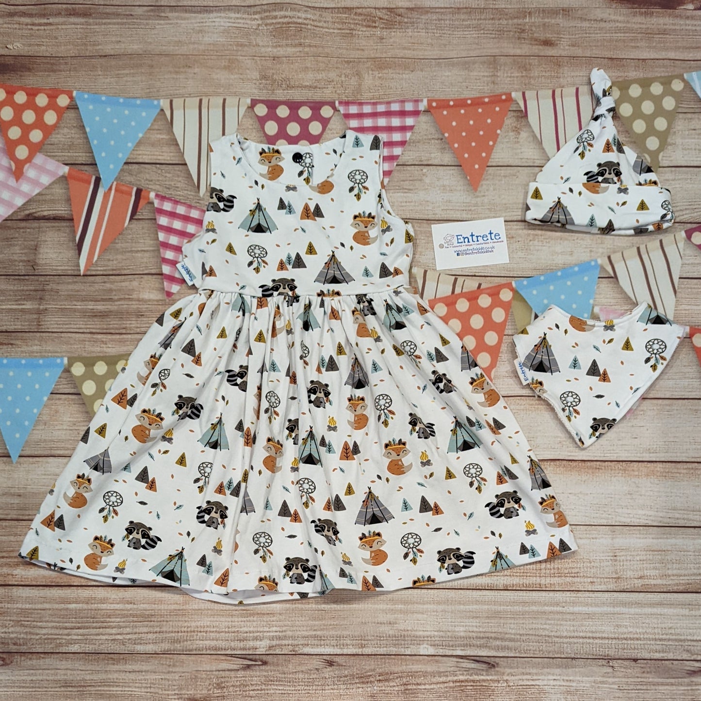 The adorable and fun fox and raccoons girls dress. Handmade using native American animals cotton jersey. Sleeveless version shown, with a matching bamboo bib and tie top hat..