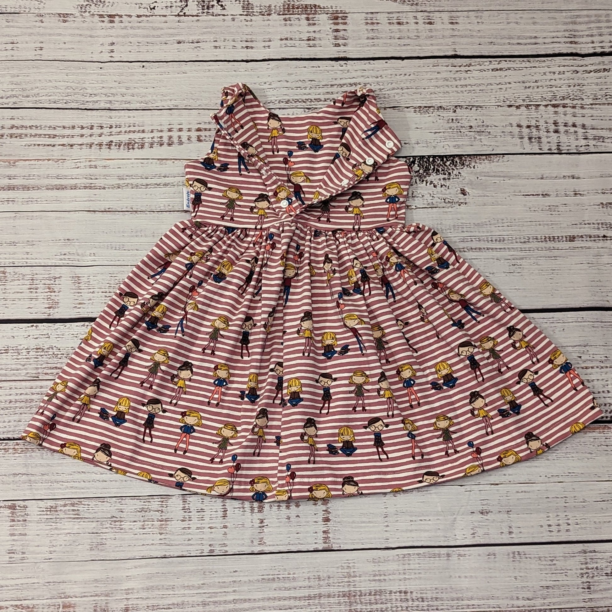 The fun girls on pink stripes girls dress. Handmade using girls on pink striped cotton jersey. Sleeveless model shown with back popper entry open, for sizes below 9 months the poppers run the length of the dress for easier changing.