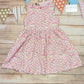 The adorable mini rainbows on white back popper dress. Handmade using mini rainbows on white cotton jersey.