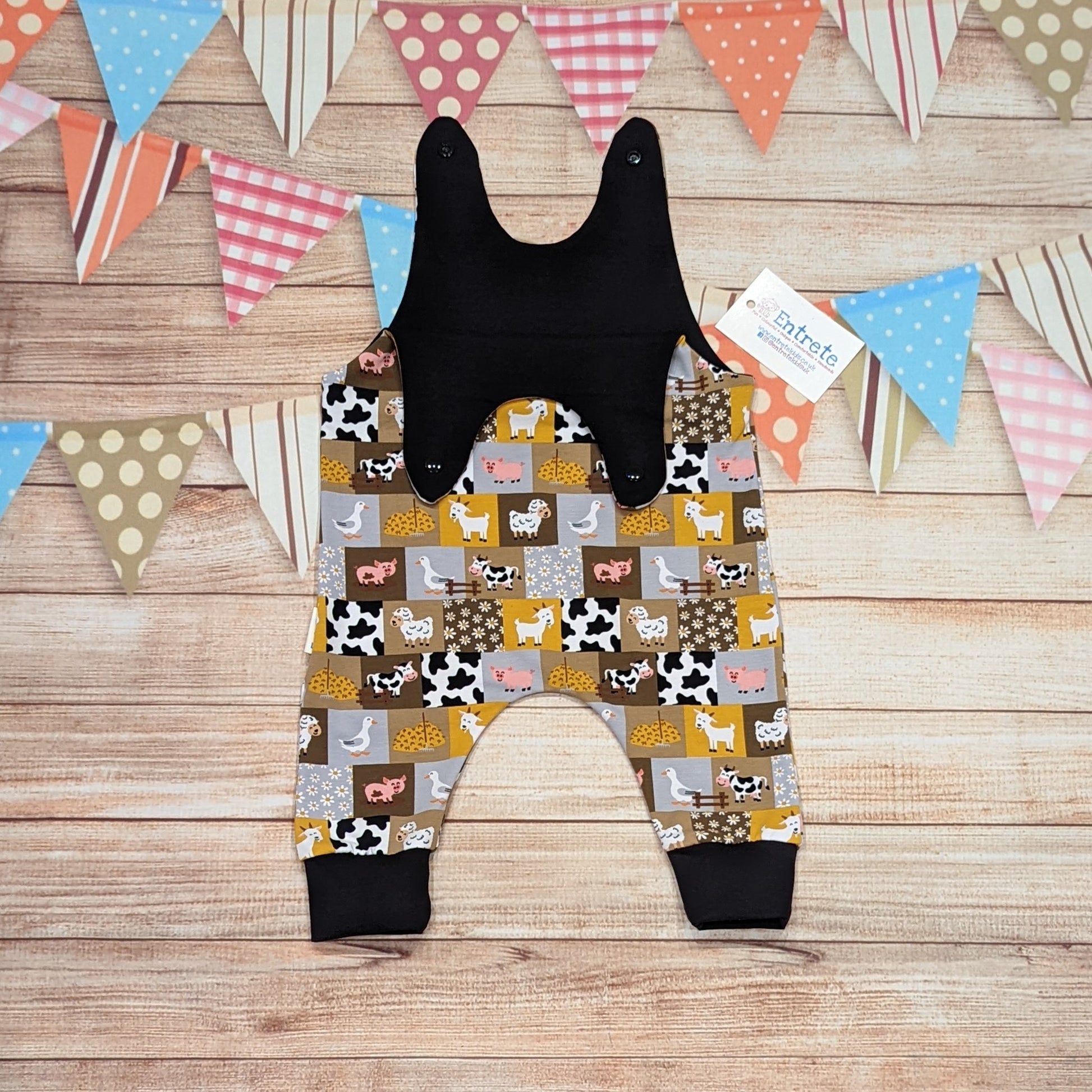 All the fun of the farmyard in this sleeveless romper. Handmade using checkboard farmyard and black cotton jerseys'. Shown with shoulder popper entry open.