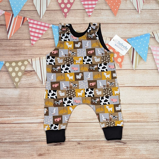 All the fun of the farmyard in this sleeveless romper. Handmade using checkboard farmyard and black cotton jerseys'.