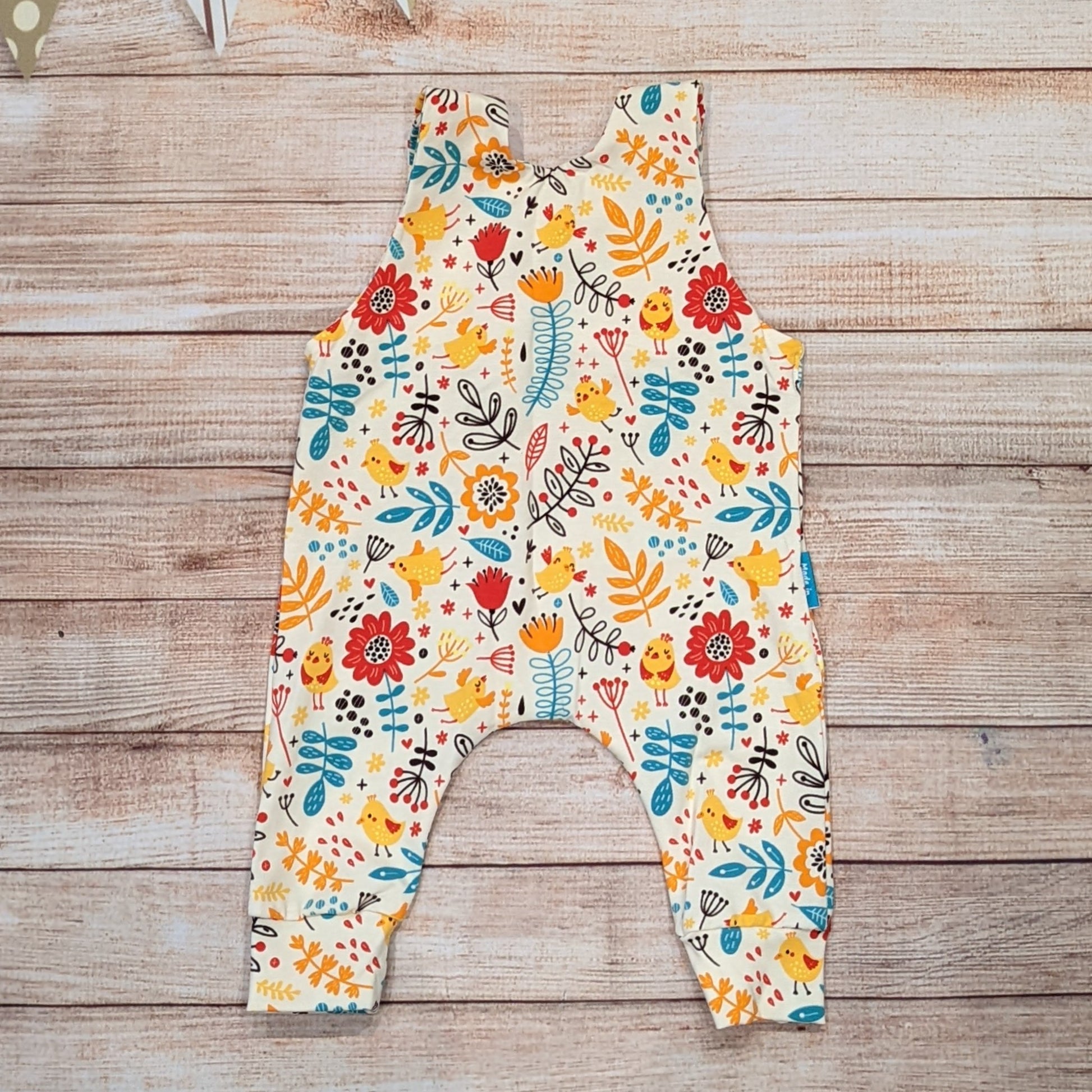 The gorgeous cream chicks and flowers sleeveless romper, perfect for spring. Handmade using cream chicks cotton jersey. Shown from the rear.