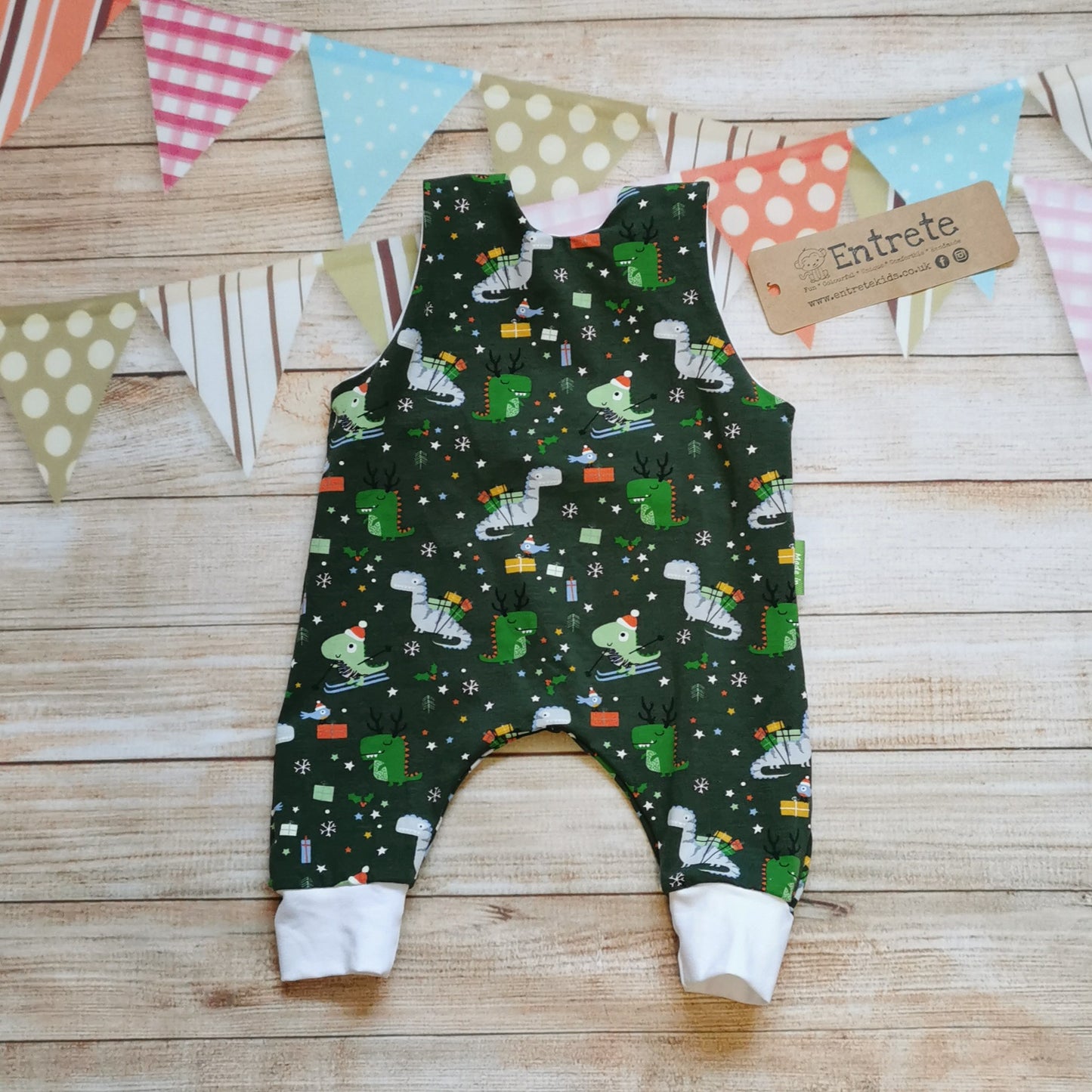 Rear view of soft and comfy sleeveless romper, handmade using the dark green festasaurus cotton jersey and white cotton jersey. The perfect Christmas gift for a little dinosaur fanatic!!