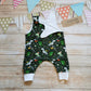 Soft and comfy sleeveless romper, handmade using the dark green festasaurus cotton jersey and white cotton jersey. Shown with one set of shoulder poppers open. The perfect Christmas gift for a little dinosaur fanatic!!