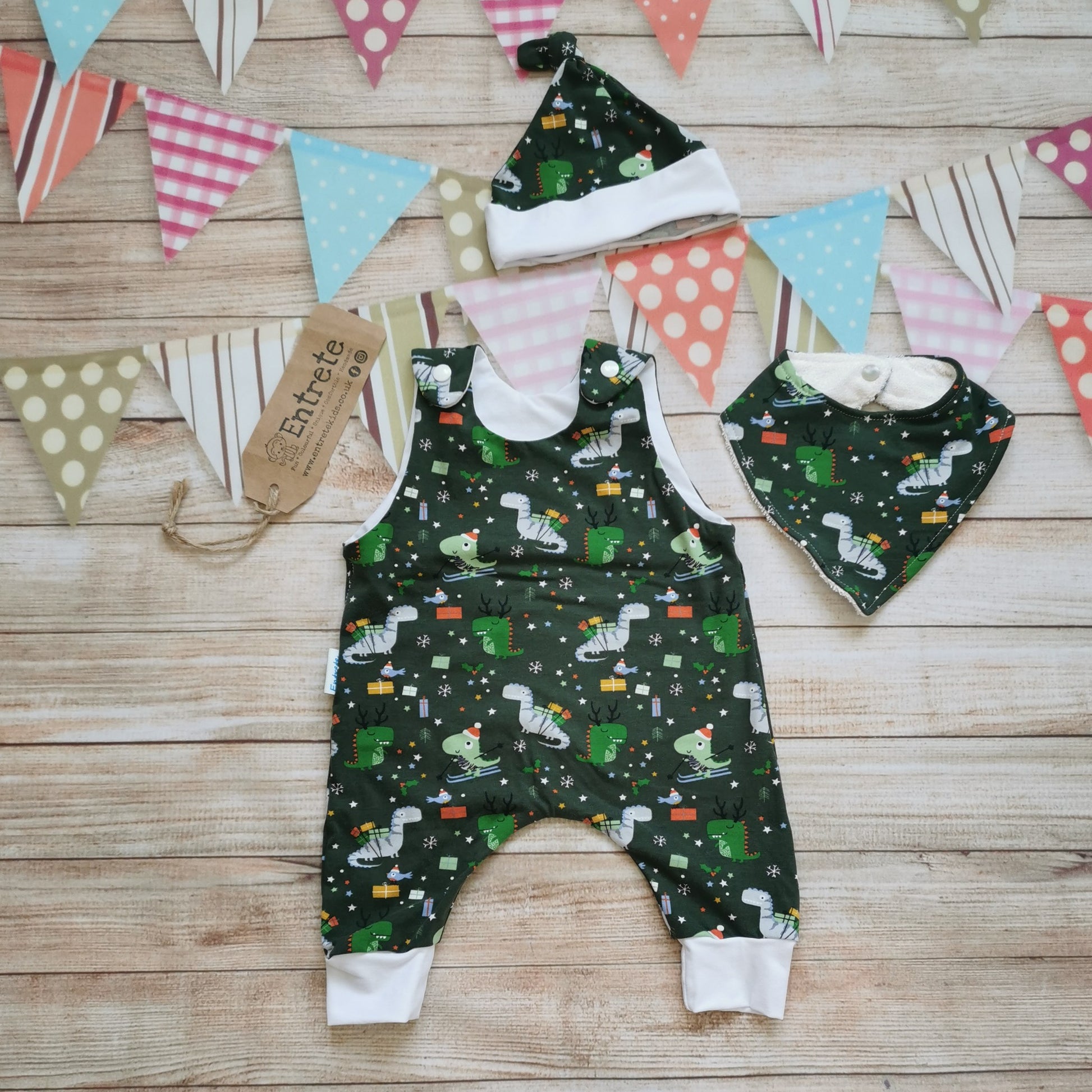 Soft and comfy sleeveless romper, handmade using the dark green festasaurus cotton jersey and white cotton jersey. The perfect Christmas gift for a little dinosaur fanatic! Shown with a matching hat and bamboo bib (sold separately)