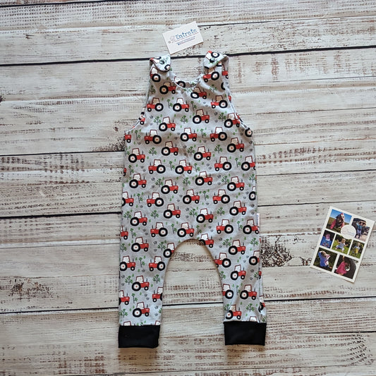 Fun red tractors on grey sleeveless romper. Handmade using grey tractors cotton jersey and black cotton ribbing.