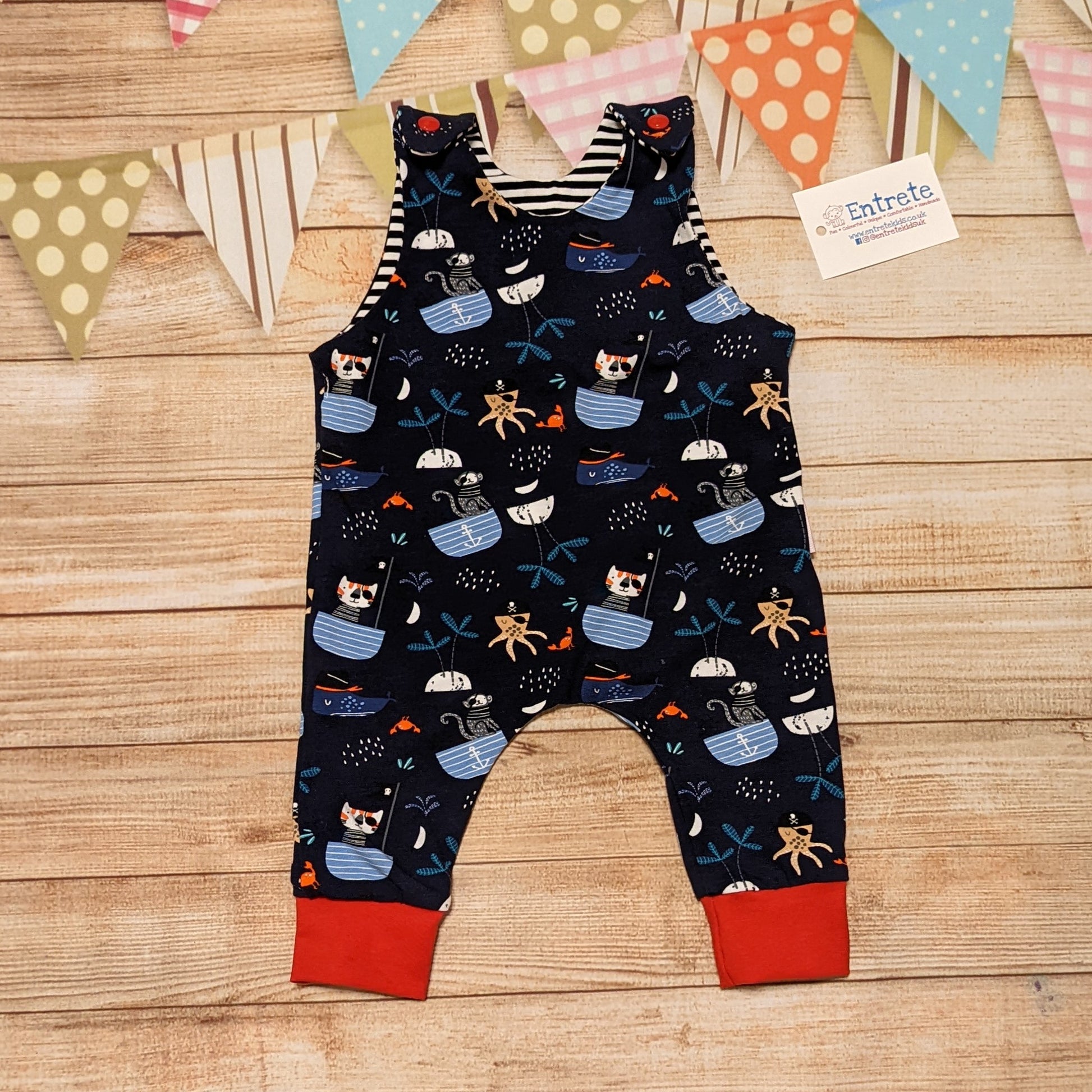 Fun and adventure await, with the pirate cats sleeveless romper. Handmade using pirate cats, red and monochrome striped cotton jersey's.