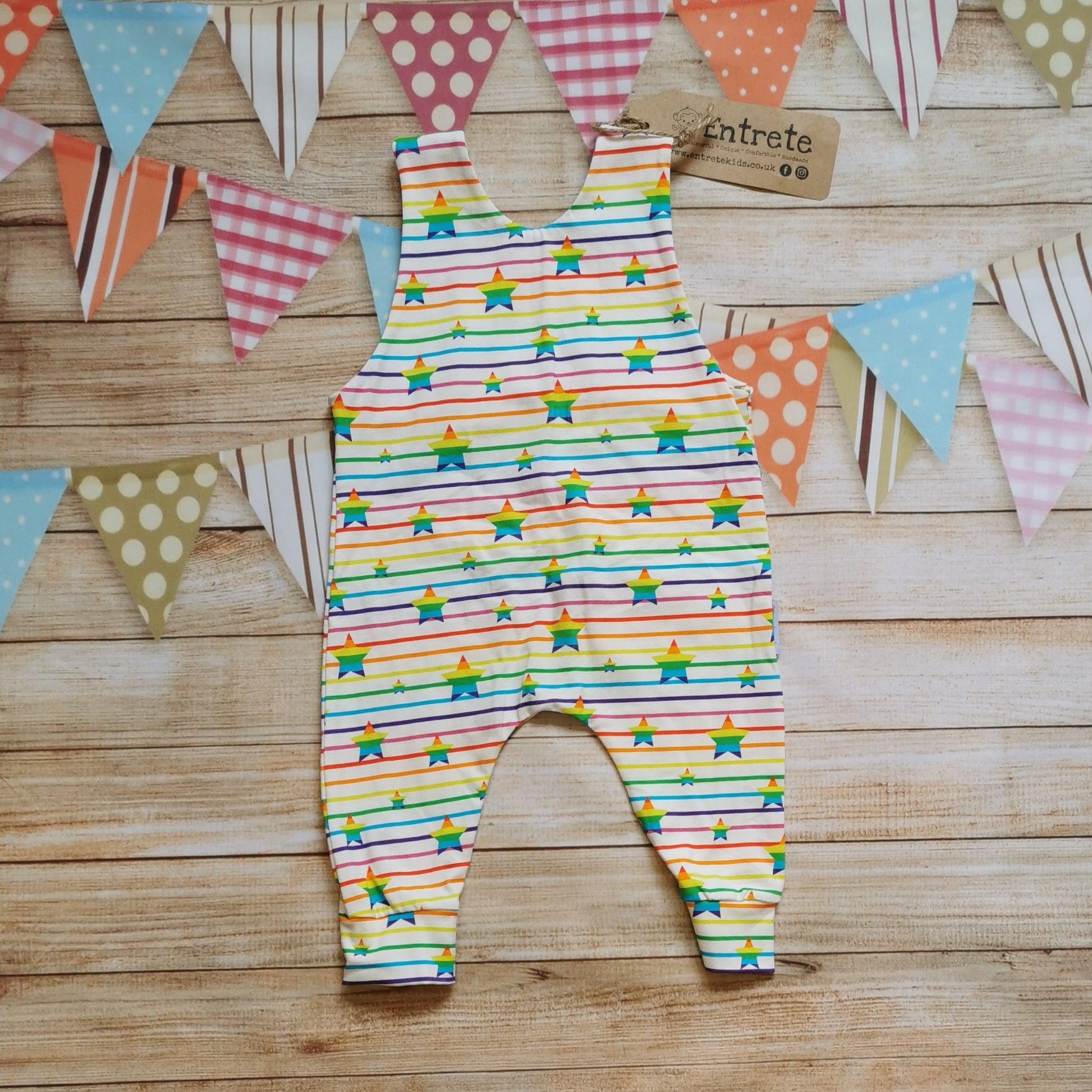 Rear of Child & Babies sleeveless romper, handmade using rainbow stars cotton jersey. Featuring shoulder popper entry.
