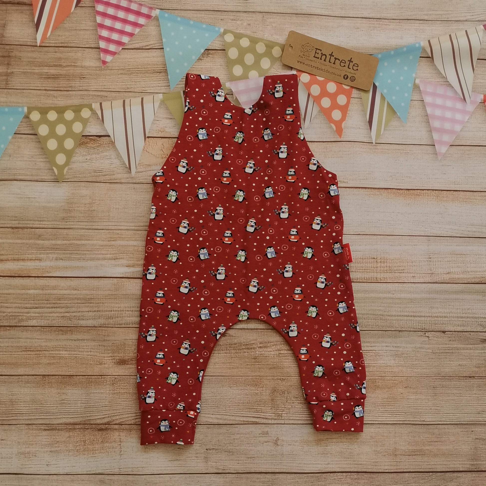 Rear of the soft and comfy sleeveless romper, handmade using the festive and fun red penguins cotton jersey. Perfect for Christmas!