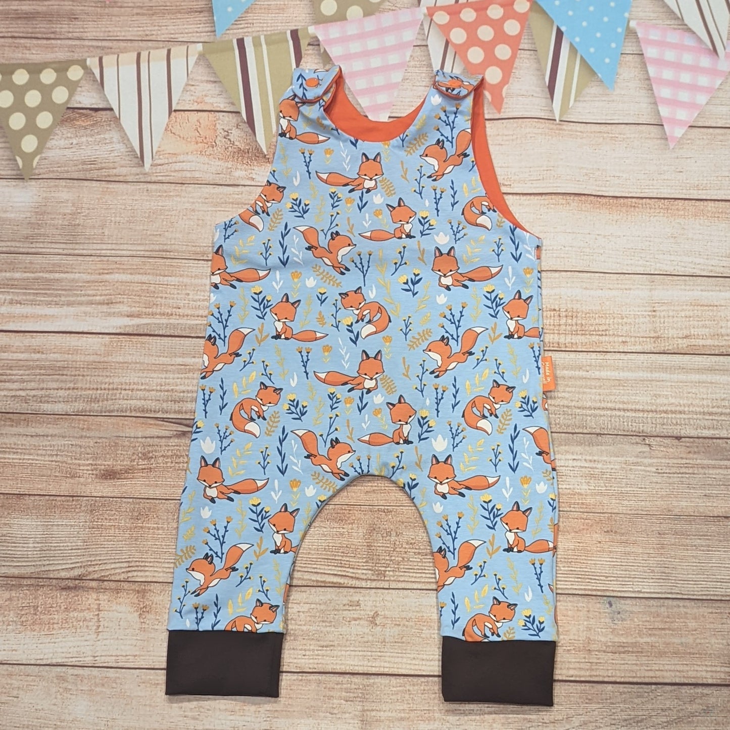 The adorable fantastic sky blue foxes romper. Handmade using sky blue foxes, orange and brown cotton jerseys'.