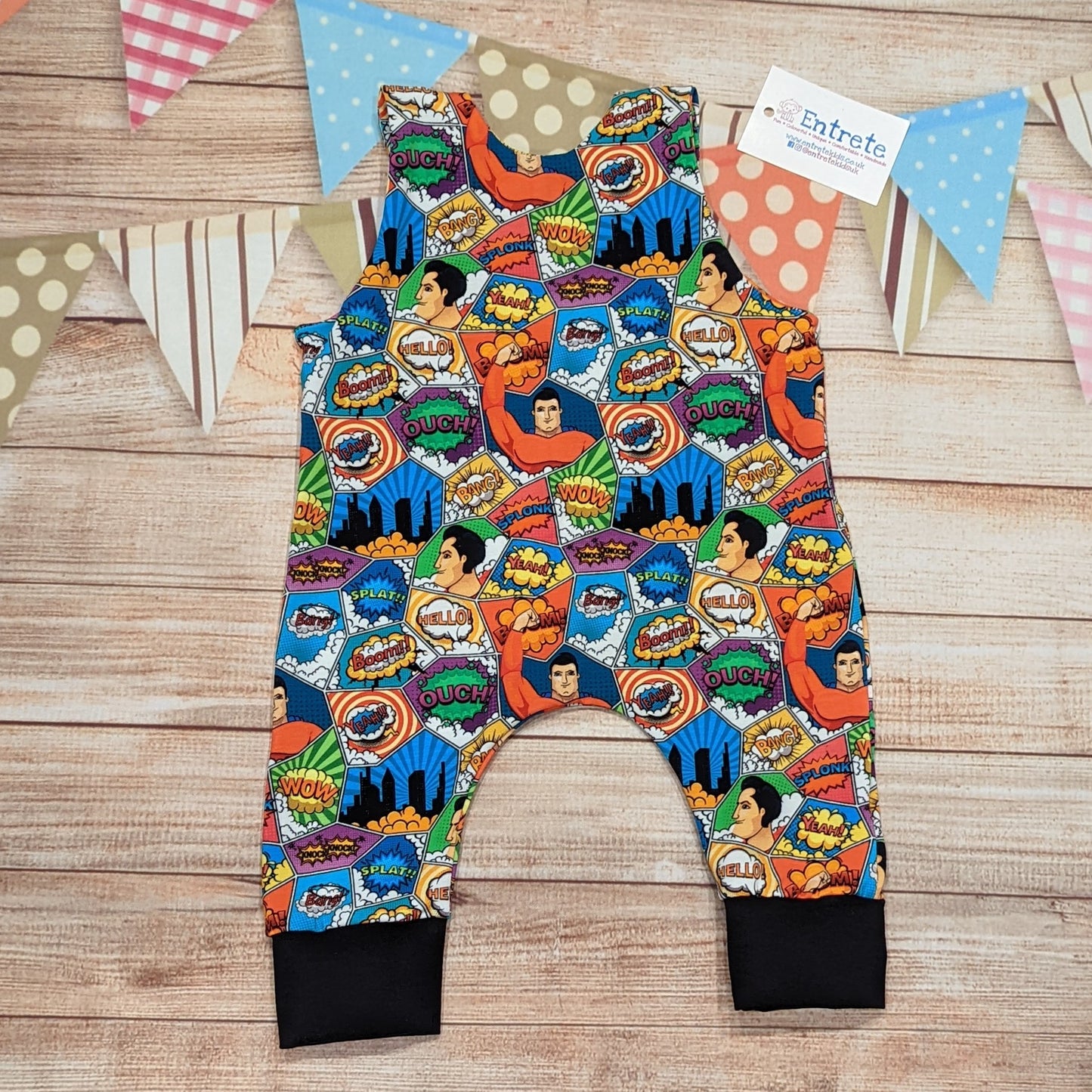 The awesome superhero sleeveless romper with it's comic strip print. Handmade using superhero and black cotton jerseys'. Shown from the rear.